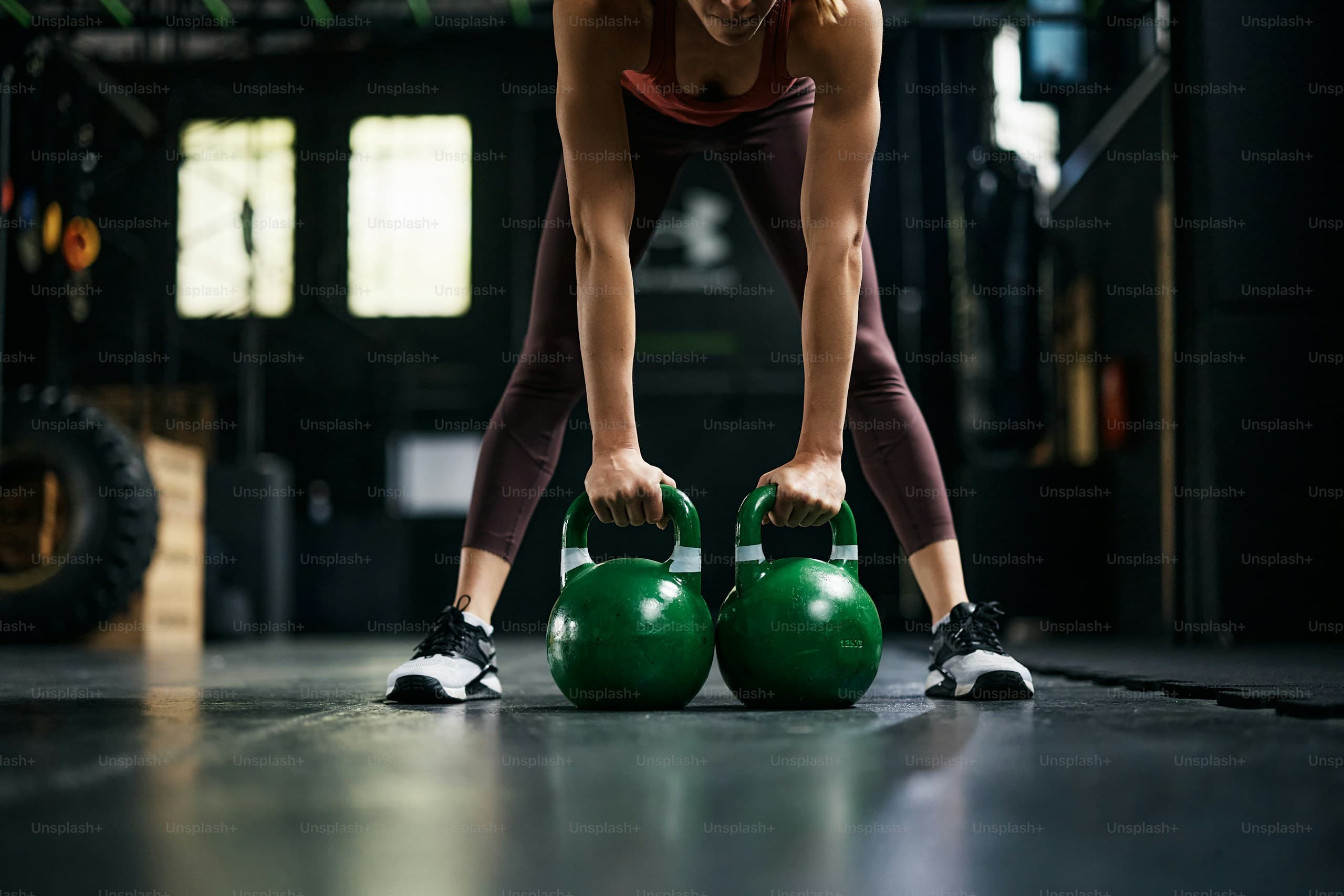 Athlete training with kettlebells